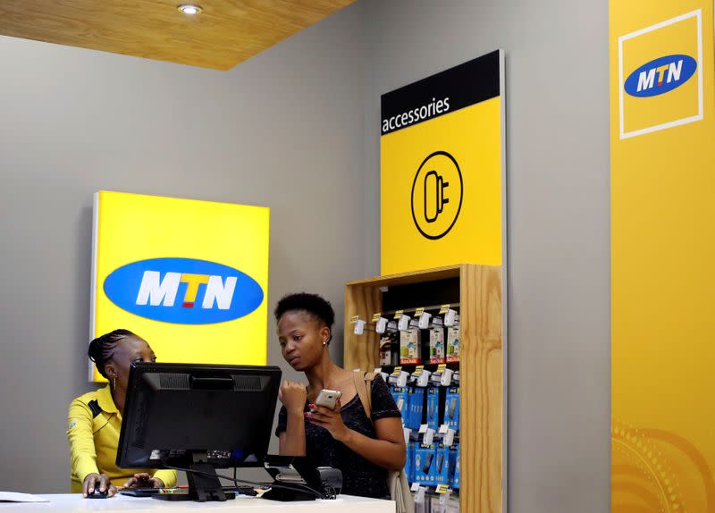 FILE PHOTO: A worker attends to a customer at an MTN shop at mall in Johannesburg