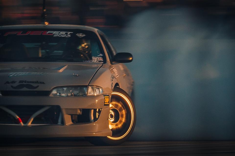 A drift car generates tire smoke on the figure eight drift track at FuelFest at the South Florida Fairgrounds and Expo Center in unincorporated Palm Beach County, Fla., on February 25, 2023. Event officials announced an attendance of over 15,000 spectators at the event's second year in Palm Beach County.