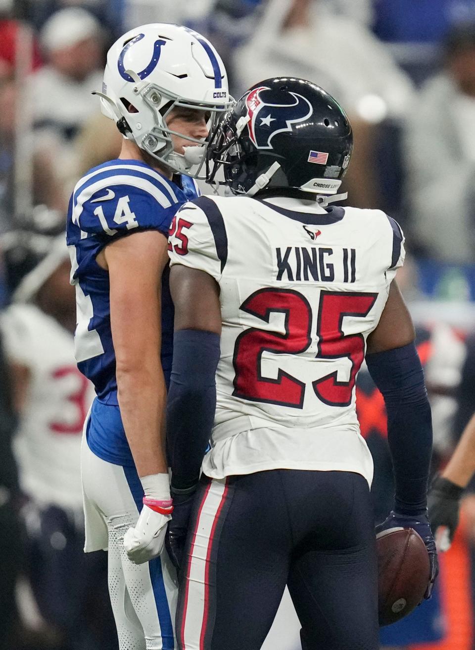 Indianapolis Colts wide receiver Alec Pierce (14) and Houston Texans cornerback Desmond King II (25) have an exchange on the field Saturday, Jan. 6, 2024, during a game against the Houston Texans at Lucas Oil Stadium in Indianapolis.