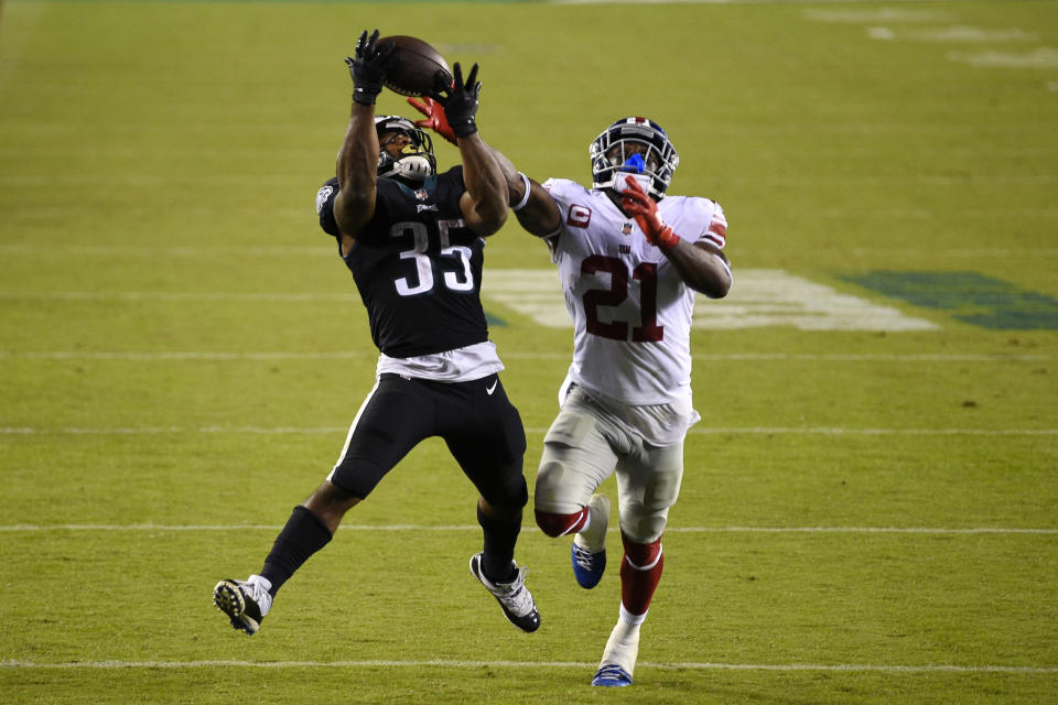 Philadelphia Eagles' Boston Scott, left, catches a touchdown pass against New York Giants' Jabrill Peppers during the second half of an NFL football game, Thursday, Oct. 22, 2020, in Philadelphia. (AP Photo/Derik Hamilton)