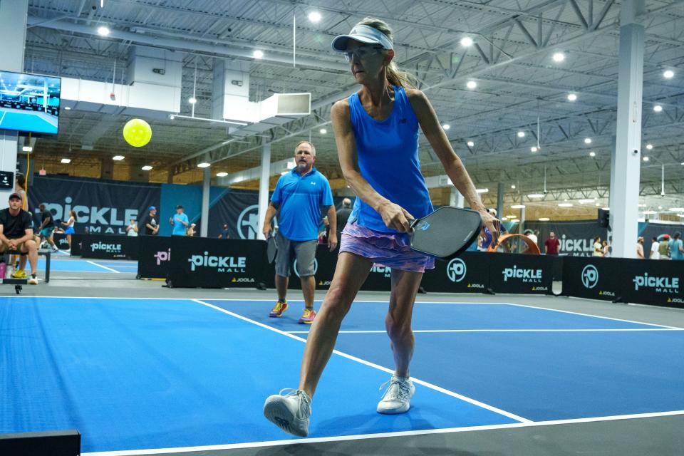 Karen (front) and Cary McCormick play pickleball at the indoor courts at Picklemall during their grand opening at Arizona Mills on Aug. 5, 2023, in Tempe.