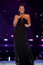 <p>Keke Palmer presented on stage in an elegant black gown.</p>