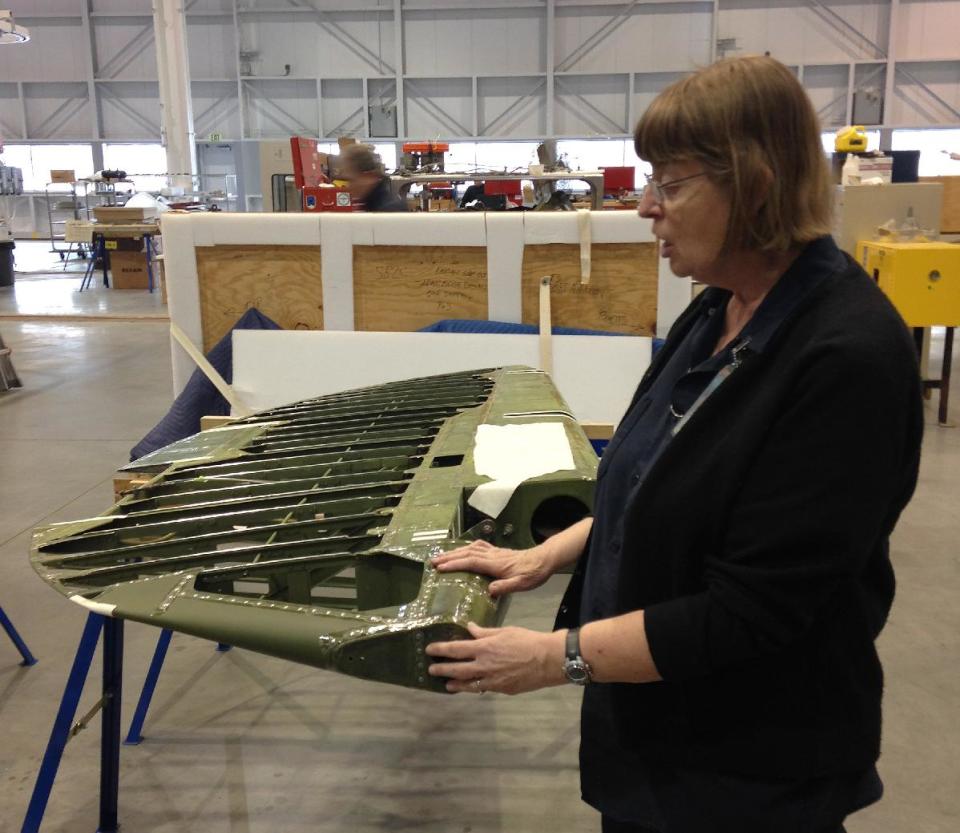 Restoration specialist Anne McCombs discusses how she will restore part of a World War II-era plane’s rudder for display at the Smithsonian, Thursday, Jan. 23, 2014, at the National Air and Space Museum’s Udvar-Hazy Center. Faced with an ongoing shortage of space for storage and care of its massive collection, the Smithsonian’s new restoration hangar for the nation’s historic aircraft and spacecraft and spacesuit collections is a bright spot for the museum complex in northern Virginia. Last year, the Smithsonian’s inspector general testified in Congress that the continued use of substandard facilities was a risk to important art and science collections. (AP Photo/Brett Zongker)