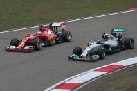 Ferrari driver Fernando Alonso of Spain, left, and Mercedes driver Nico Rosberg of Germany, right, drive their cars during the practice session for Sunday's Chinese Formula One Grand Prix at Shanghai International Circuit in Shanghai, Friday, April 18, 2014. (AP Photo/Eugene Hoshiko)