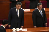 Chinese President Xi Jinping, left and Chinese Premier Li Qiang, right, attend the opening session of the Chinese People's Political Consultative Conference in the Great Hall of the People in Beijing, Monday, March 4, 2024. (AP Photo/Ng Han Guan)
