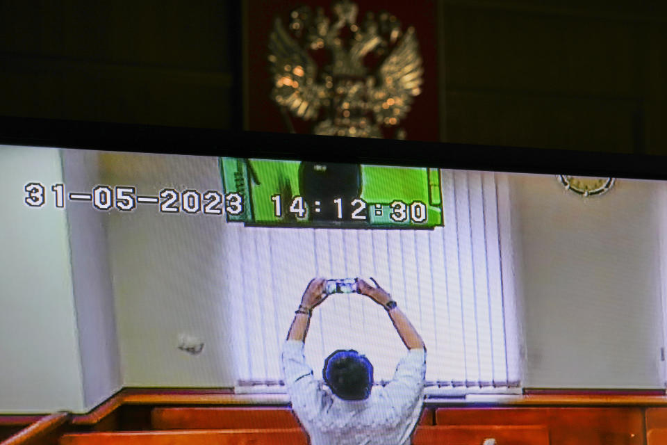 Russian opposition leader Alexei Navalny is partially seen on a TV screen, as he appears in a video link provided by the Russian Federal Penitentiary Service in a courtroom at Moscow City Court in Moscow, Russia, on Wednesday, May 31, 2023. Imprisoned Russian opposition leader Alexei Navalny said in April that he was facing new extremism and terrorism charges that could keep him behind bars for life. (AP Photo/Alexander Zemlianichenko.)