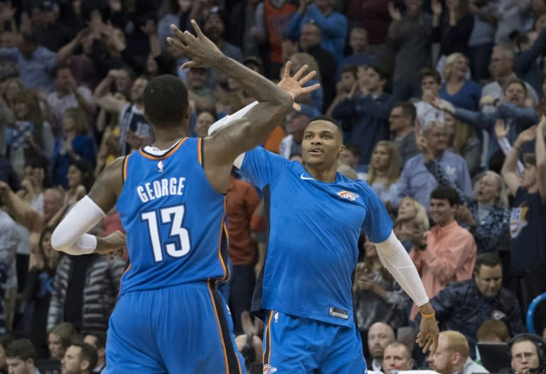 Paul George and Russell Westbrook of the Oklahoma City Thunder celebrate during the second half of their NBA game against the Golden State Warriors, at the Chesapeake Energy Arena in Oklahoma City, on November 22, 2017