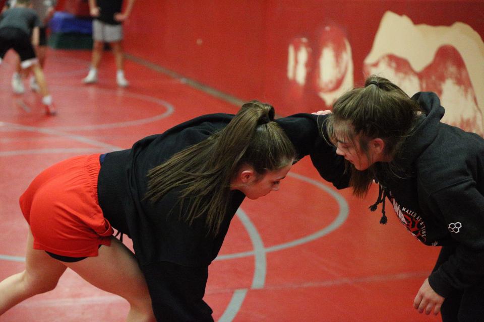 West Lafayette sophomore Isabel Kaplan (left) thrusts her left arm at older sister Rose Kaplan (right) during practice on Wednesday, Jan. 3, 2024 in preparation for the Semi-State Championships this Friday at Penn High School.