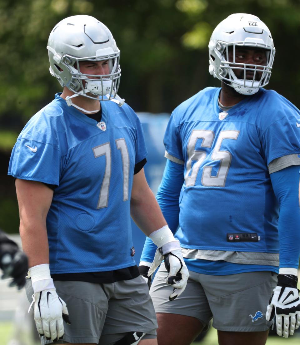 Lions offensive linemen Logan Stenberg, left, and Obinna Eze on the field during practice during minicamp on Thursday, June 9, 2022, in Allen Park.
