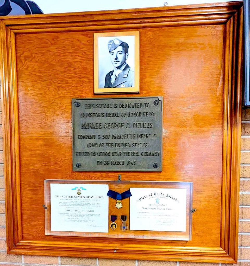 This display has been in the lobby of George J. Peters Elementary School in Cranston since 1958. In addition to the Medal of Honor, the exhibit includes his Purple Heart and Rhode Island Cross.