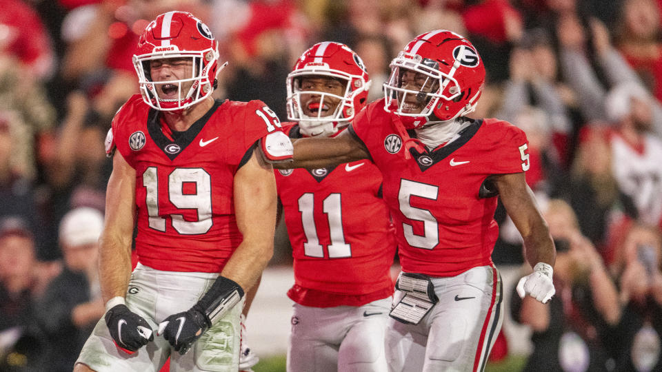 Georgia tight end Brock Bowers, left, reacts after a touchdown against Kentucky with wide receiver Arian Smith and wide receiver Rara Thomas, right, during the second half of an NCAA college football game Saturday, Oct. 7, 2023, in Athens, Ga. (AP Photo/Hakim Wright Sr.)