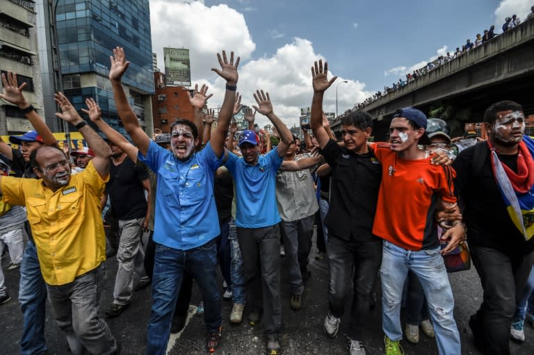 Venezuelan opposition leader and former presidential candidate Henrique Capriles (C) and opposition lawmaker Jose Manuel Olivares (L) take part in a protest in Caracas