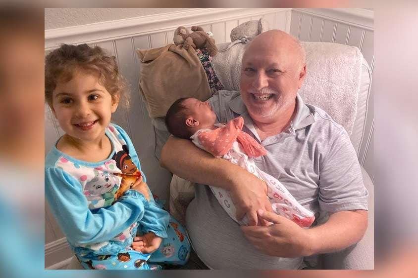 Perry Buchalter in early March 2020 in Jupiter, with granddaughters Raya (left) and Leah. He died of COVID-19 on April 7.