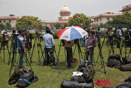 Television journalists are seen outside the premises of the Supreme Court in New Delhi, India August 22, 2017. REUTERS/Adnan Abidi