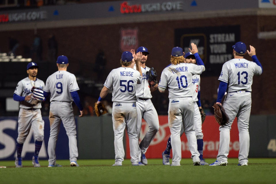 Los Angeles Dodgers players celebrate a 2-1 victory over the San Francisco Giants in a baseball game Friday, May 21, 2021, in San Francisco. (AP Photo/D. Ross Cameron)