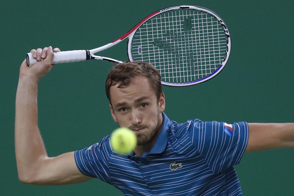 Daniil Medvedev of Russia eyes on the ball as he plays against Stefanos Tsitsipas of Greece in their men's singles semifinals match at the Shanghai Masters tennis tournament at Qizhong Forest Sports City Tennis Center in Shanghai, China, Saturday, Oct. 12, 2019. (AP Photo/Andy Wong)