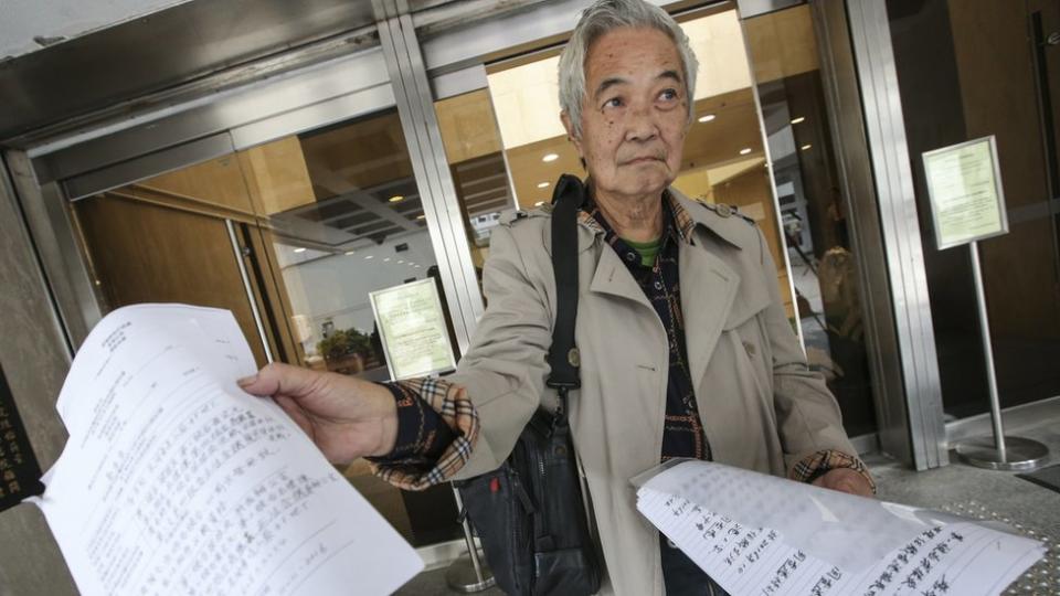 郭卓堅在香港高等法院門外向記者展示起訴文書（資料圖片）