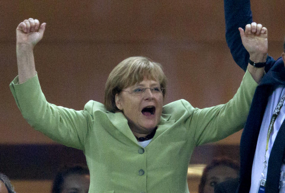 German Chancellor Angela Merkel celebrates during the Euro 2012 soccer championship quarterfinal match between Germany and Greece in Gdansk, Poland, Friday, June 22, 2012.(AP Photo/Gero Breloer)