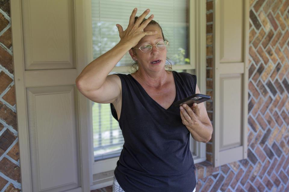 Terri Straka stands on the porch of her new home while she finalizes details with a real estate agent in Myrtle Beach, South Carolina. (Credit: Madeline Gray for The Washington Post via Getty Images)