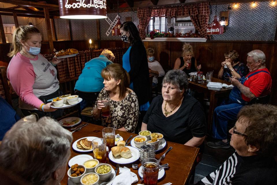 Patrons have their orders delivered by waitress Kaitlyn Davis, left, at The Whistle Stop restaurant in downtown Glendale, Ky. The restaurant is the crown jewel of the historic Main Street and has been drawing in customers to the area for southern-style cooking since 1975. Sept. 28, 2021