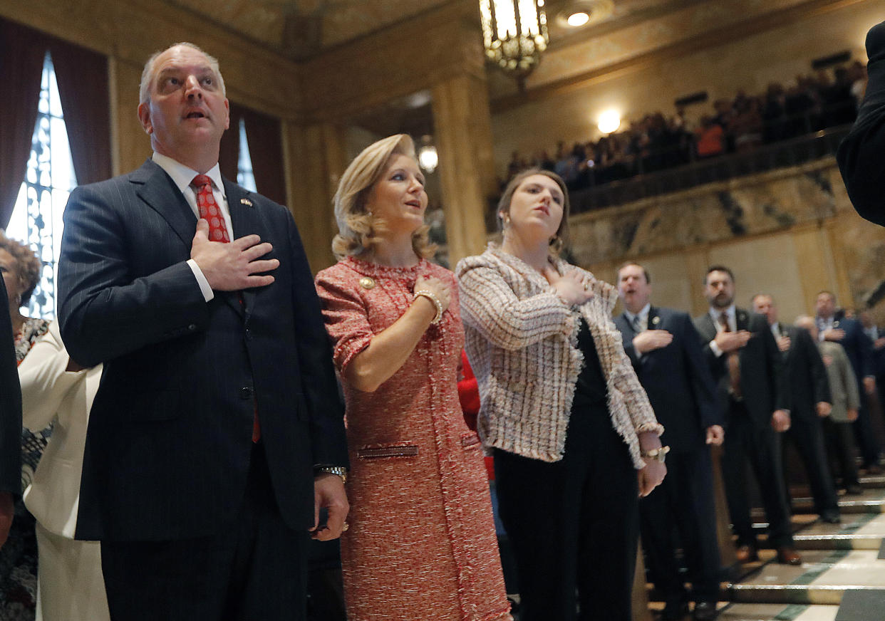 Louisiana Gov. John Bel Edwards with his wife, Donna Edwards, and their daughter Sarah Ellen Edwards during the pledge of allegiance April 8 at the opening of the annual state legislative session in Baton Rouge. (Photo: Gerald Herbert, Pool, via ASSOCIATED PRESS)