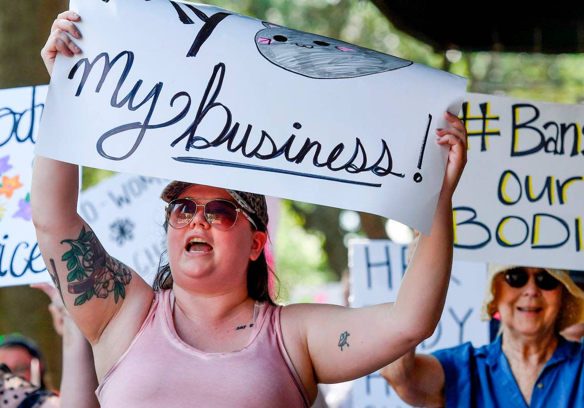 Event organizer Lacey Albritton chants ““Hey Hey Ho Ho, your backward views got to go,” as she marches with hundreds down Cherry Street during a pro-choice march and rally Sunday in downtown Macon.