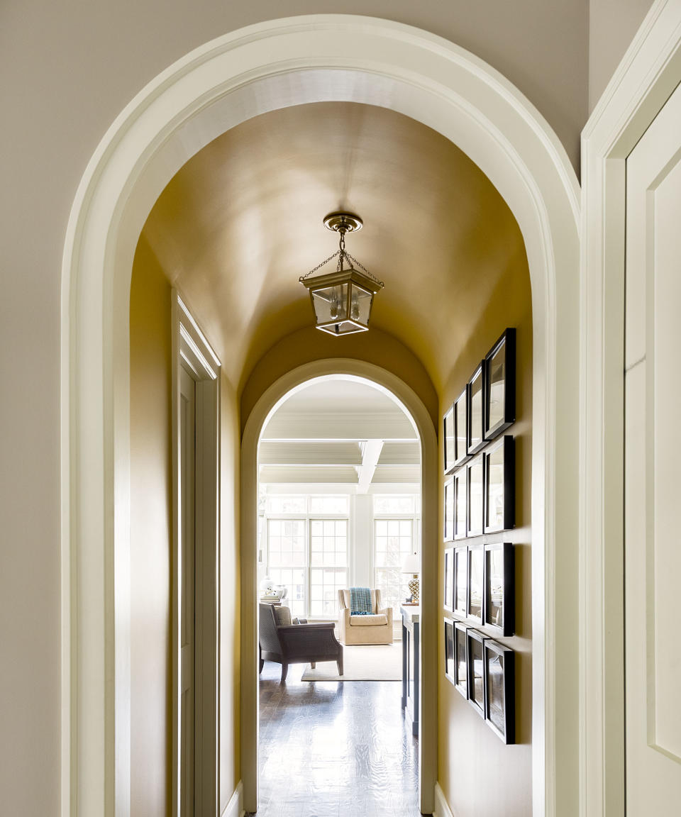 <p> In a narrow hallway with very little space for furniture or bulky decor, make an impact with without straying more than an inch from the wall.&#xA0; </p> <p> In this Lake Michigan home by&#xA0;M. Lavender Interiors, a small arched hall is turned into a space inspired by the owners&#x2019; travels in Africa. The walls are painted in Farrow &amp; Ball&apos;s Sudbury Yellow to echo the color of the grasses in the Serengeti, while one is bedecked by framed photographs they took on a trip there to create a stunning gallery wall.&#xA0; </p>