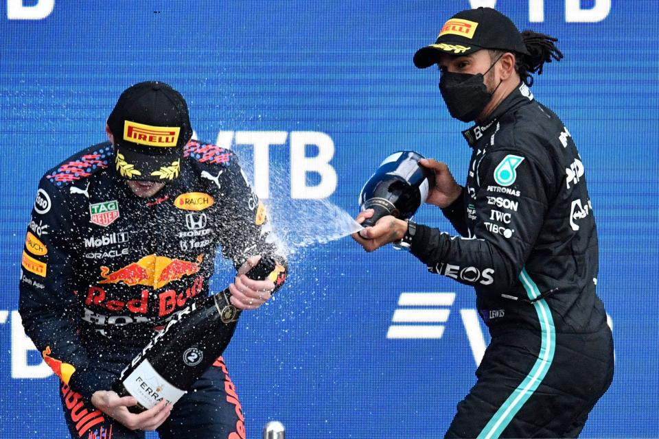 Lewis Hamilton, right, celebrates on the podium with Max Verstappen after the Formula 1 Russian Grand Prix on Sept. 26, 2021.