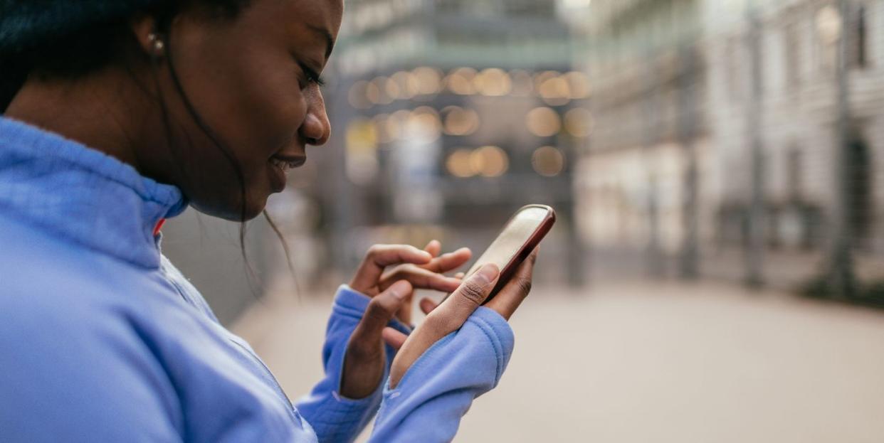 woman uses running app during workout