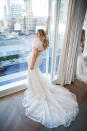 <p>Lawrence wears a cropped furry bolero with her lace bridal gown by Justin Alexander. (Photo: courtesy of Justin Alexander) </p>