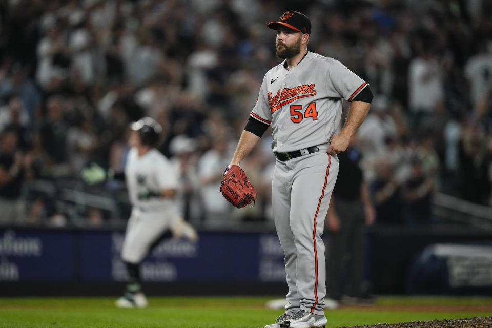 Baltimore Orioles relief pitcher Danny Coulombe (54) reacts as New York Yankees' Harrison Bader runs the bases after hitting a three-run home run during the eighth inning of a baseball game Monday, July 3, 2023, in New York. (AP Photo/Frank Franklin II)