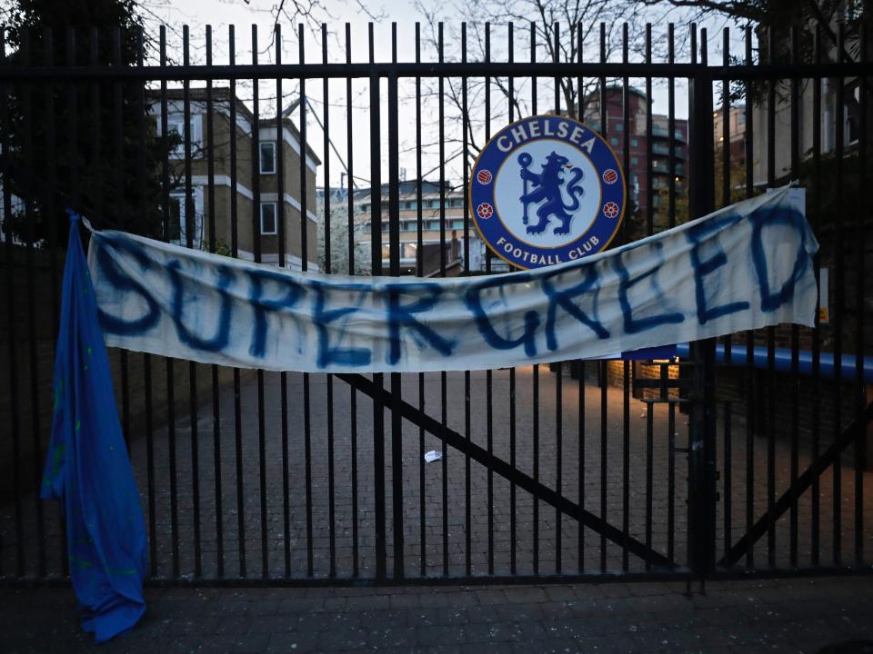 A banner hangs from one of the gates of Stamford Bridge (AP)