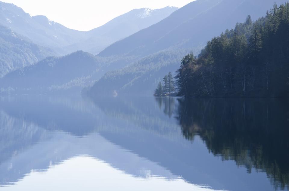 Mountains are reflected in a lake.