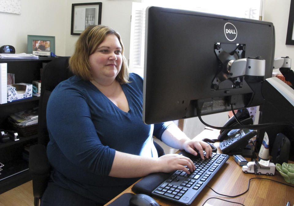 In this May 15, 2019, photo, Beth Dow, a commercial property adjuster, works from home in Bennington, Vt. She and her husband recently moved to Vermont from Colorado through a Vermont program to attract new residents. (AP Photo/Lisa Rathke)