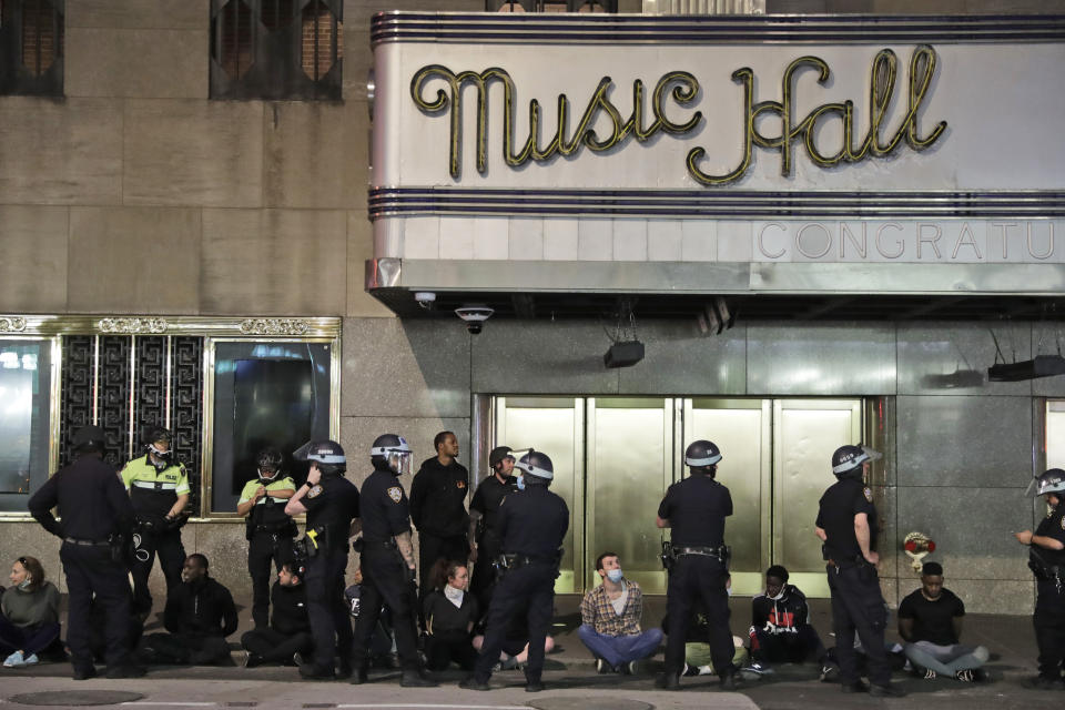 Police officers arrest a large group of people at Radio City Music Hall in New York, Monday, June 1, 2020. Demonstrators took to the streets of New York City to protest the death of George Floyd, a black man who died in police custody in Minneapolis on May 25. (AP Photo/Seth Wenig)