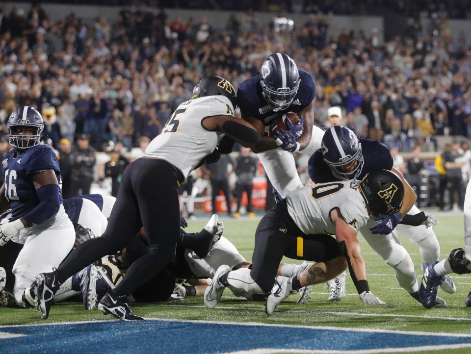 Georgia Southern running back Tyler Jordan leaps over the top for a touchdown during Saturday night's game against Appalachian State.