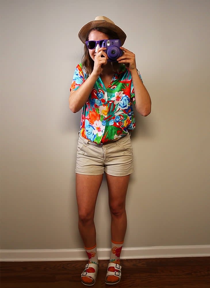 A woman is dressed as a tourist as part of a DIY Halloween costume.
