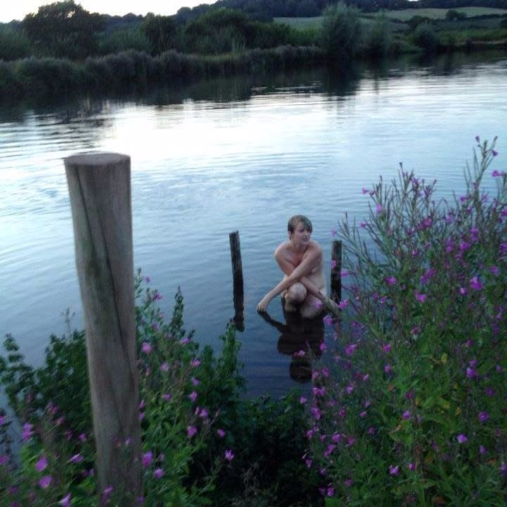 Beatrice Berry, aged 19, in a lake near her home, the first time she went nude in public. (Supplied)