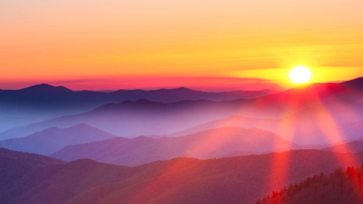 sunset on a foggy mountain range that goes with quote by paulo coelho, don’t forget, beautiful sunsets need cloudy skies