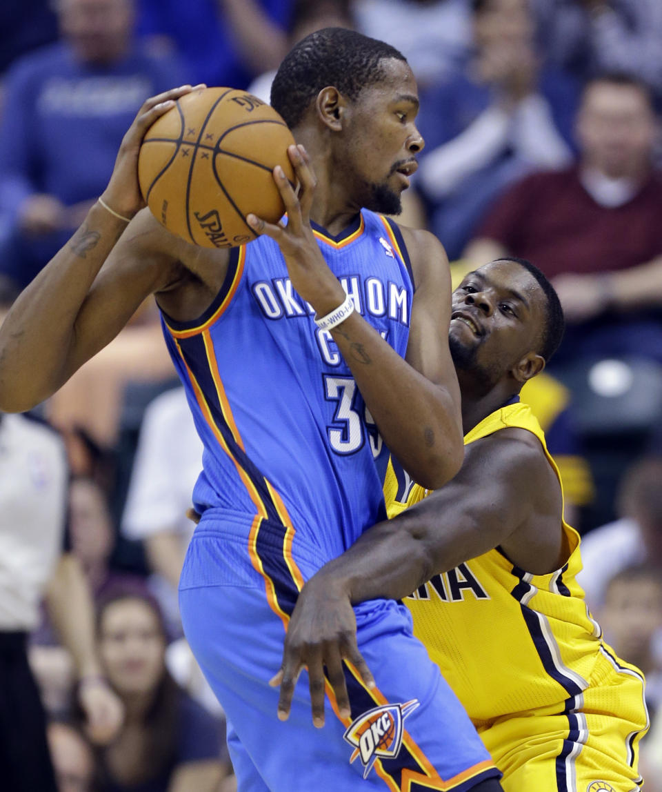 Indiana Pacers guard Lance Stephenson, right, defends against Oklahoma City Thunder forward Kevin Durant in the second half of an NBA basketball game in Indianapolis, Sunday, April 13, 2014. The Pacers defeated the Thunder 102-97. (AP Photo/Michael Conroy)