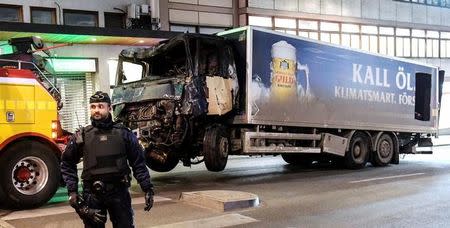 Tow trucks pull away the beer truck that crashed into the department store Ahlens after plowing down the Drottninggatan Street in central Stockholm, Sweden, April 8, 2017. Maja Suslin/TT News Agency/via Reuters