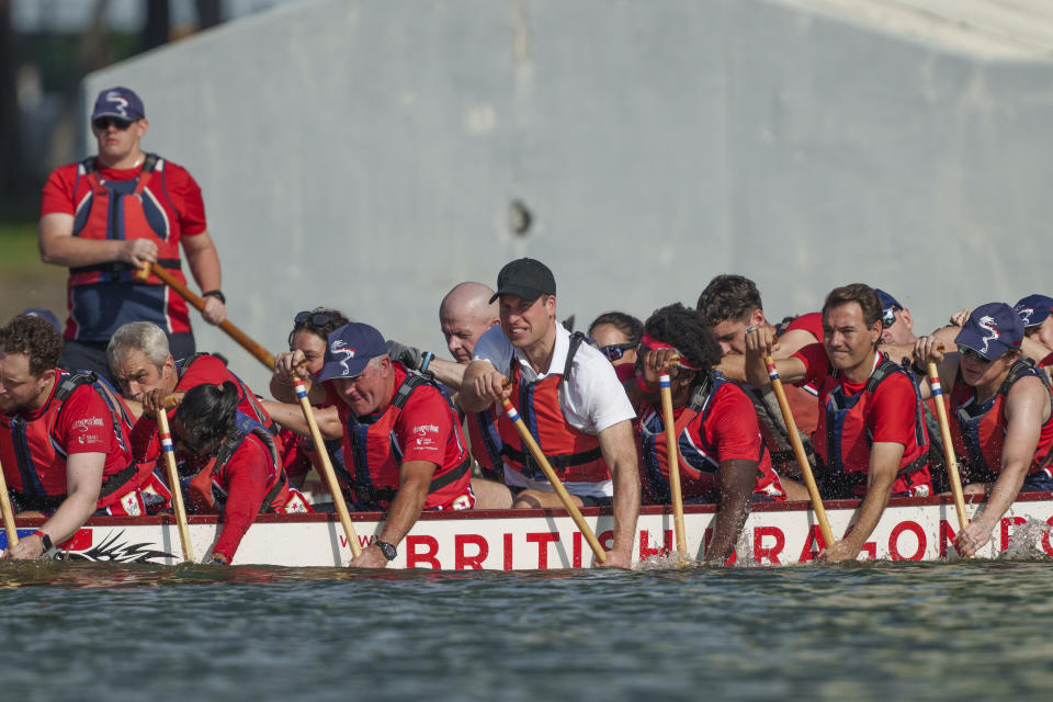 Britain's Prince William, center, participates in a dragon boat event in Singapore, Monday, Nov. 6, 2023. (AP Photo/Vincent Thian)