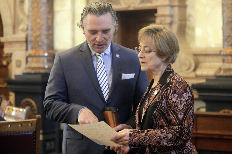 FILE - Kansas Senate President Ty Masterson, left, R-Andover, confers with Senate health committee Chair Beverly Gossage, right, R-Eudora, ahead of a vote on a broad transgender bathroom bill, Tuesday, April 4, 2023, at the Statehouse in Topeka, Kan. U.S. states with laws restricting what bathrooms transgender kids can use in public schools are wrestling with how those laws will be enforced. At least 10 states have enacted such laws and transgender, nonbinary and gender-noncomforming people expect states to rely on what they call vigilante enforcement by private individuals. (AP Photo/John Hanna, File)
