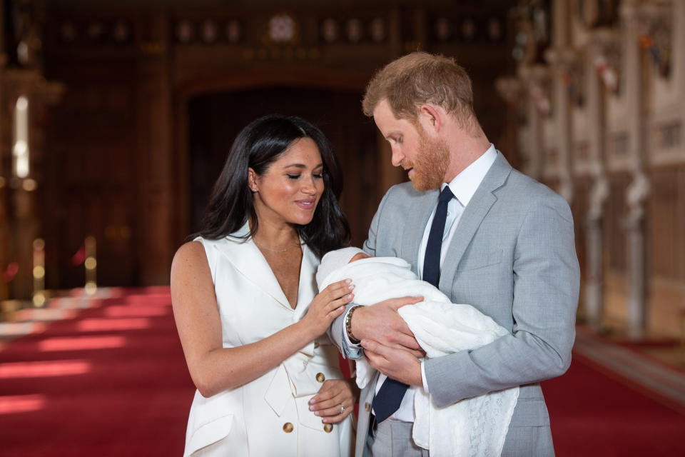 Prince Harry, Duke of Sussex and Meghan, Duchess of Sussex, pose with their newborn son Archie Mountbatten Windsor during a photocall in St George's Hall at Windsor Castle 