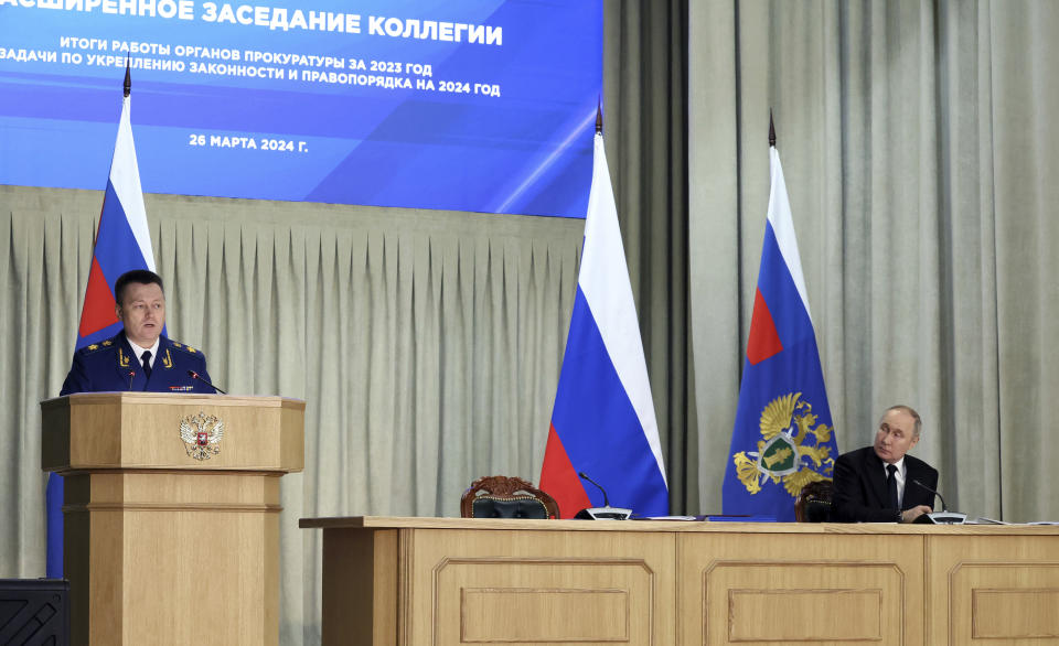 Russian President Vladimir Putin, right, and Prosecutor General Igor Krasnov attend an expanded meeting of the Prosecutor General's Office board in Moscow, Russia, Tuesday, March 26, 2024. (Valeriy Sharifulin, Sputnik, Kremlin Pool Photo via AP)