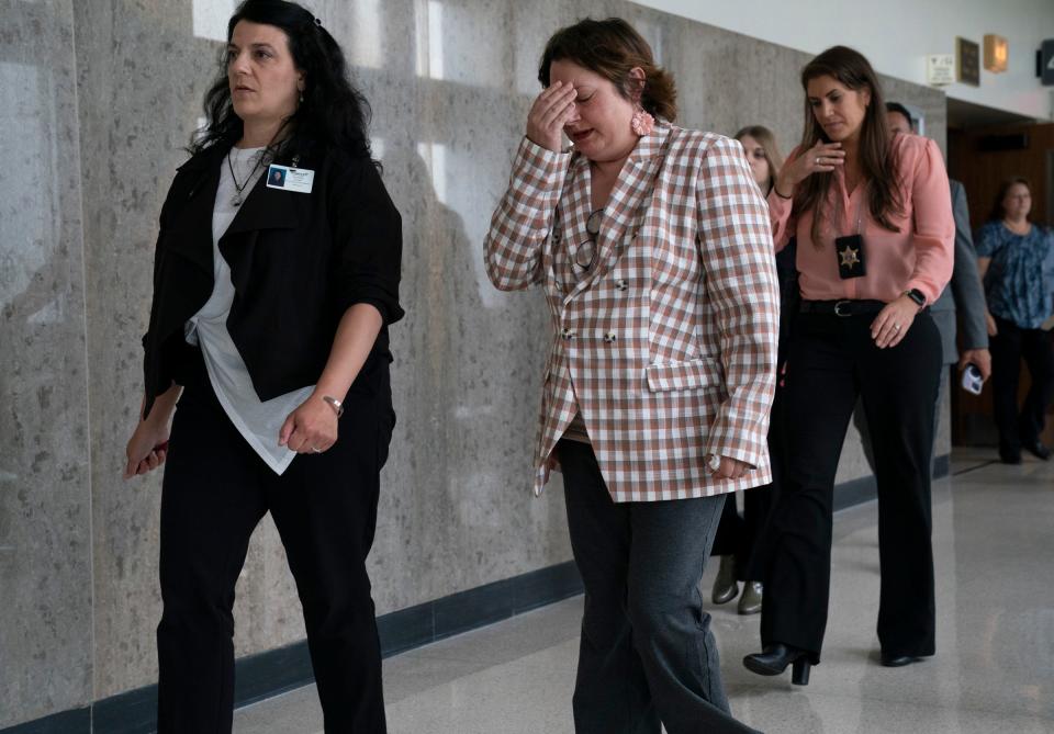 Nicole Kennedy left, escorts Phoebe Arthur’s mom, Sandra Cunningham, during a break as Oakland County Sheriff Sgt. Stephanie Zajac follows close behind as a hearing is held at the Oakland County Court House on Friday, July 28, 2023, to determine whether Ethan Crumbley will serve a life sentence without parole for the Oxford School shootings where he murdered four students and injured seven others in the 2021 shooting massacre.