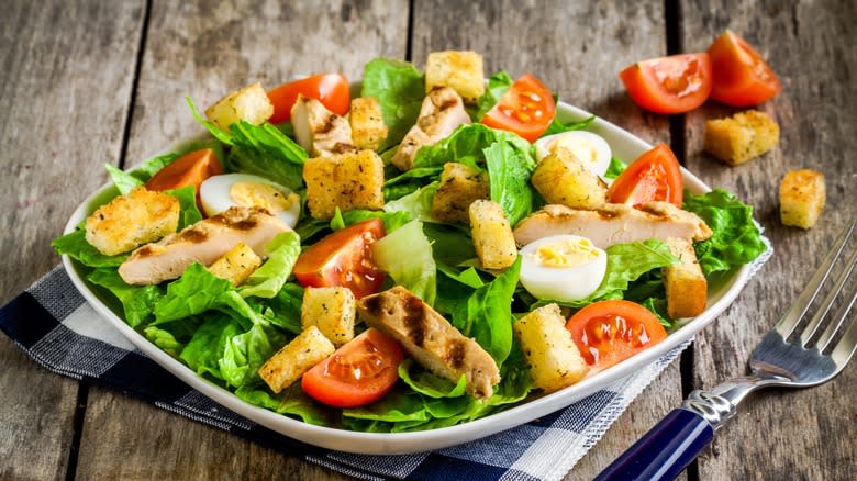 Lettuce, tomato, egg, and chicken salad with croutons