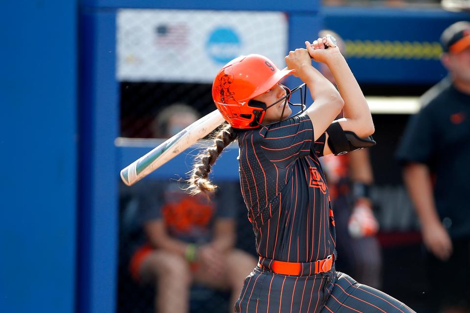Oklahoma State's Chyenne Factor (9) hits a double in the first inning of a Women's College World Series softball game between the Oklahoma State University Cowgirls (OSU) and the Florida Gators at USA Softball Hall of Fame Stadium in Oklahoma City, Saturday, June 4, 2022. Oklahoma State won 2-0.