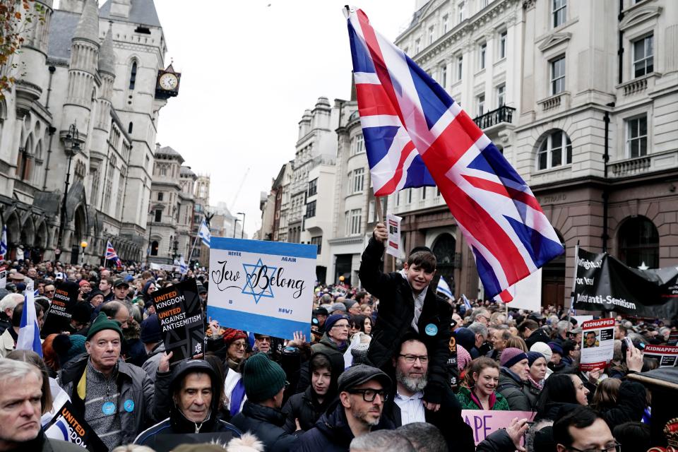 Signs read ‘Jews belong' and ‘United Kingdom against Antisemitism’ (Jordan Pettitt/PA Wire)