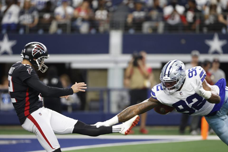 Atlanta Falcons punter Dustin Colquitt has his punt blocked by Dallas Cowboys defensive end Dorance Armstrong (92) in the first first half of an NFL football game in Arlington, Texas, Sunday, Nov. 14, 2021. (AP Photo/Ron Jenkins)